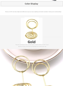 Macro detail of gold spiral base and circular clip for metal tabletop card holder