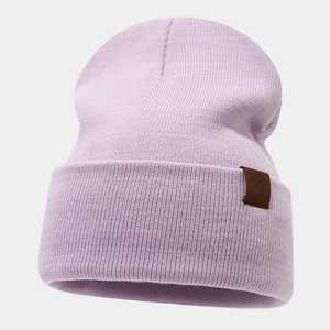 Detail of light purple knitted beanie with fine ribbing and snowflake leather patch