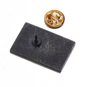 Detailed back view of golden geometric brooch featuring a butterfly clutch and pin fastener