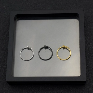 Three-piece stainless steel nose rings in silver, black, and gold with bead detail