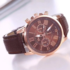 Detailed macro view of Geneva quartz watch with rose gold case and brown leather strap