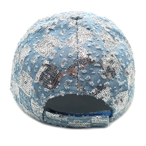 Detail of light blue denim baseball cap showing silver sequins and adjustable strap