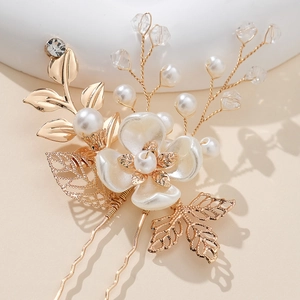 Handmade bridal hair pin with golden leaves, pearls, and crystals for weddings