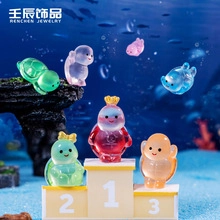 Miniature resin sea animals with crowns on blue sand underwater scene for DIY crafts