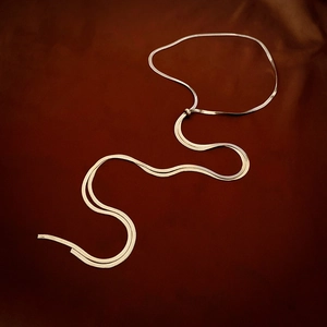 Elegant gold snake bone chain necklace featuring a Y-shaped drop design on velvet