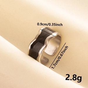 Macro detail of irregular wavy stainless steel ring with black enamel inlay and dimensions