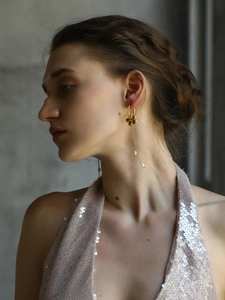 Close-up of elegant 18K gold plated flower pearl tassel earrings on female model