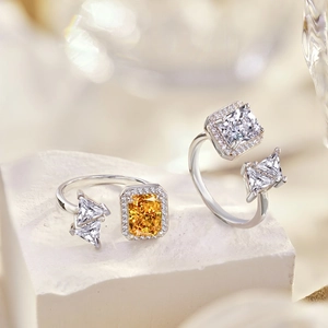 Macro detail of S925 sterling silver rings with square cut yellow and clear cubic zirconia