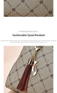 Detail of golden cat pendant and dark red leather tassel on a textured handbag