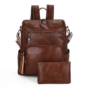 Vintage brown pebbled leather backpack with matching pouch and fringe tassels