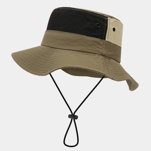 Detail of waterproof outdoor hat with khaki, black, and beige contrast stitching