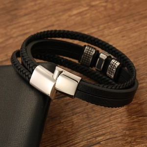 Detail of multi-layer leather bracelet featuring Star of David and steel clasp