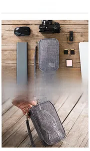 Waterproof grey digital accessory storage bag with hand strap and icon labels