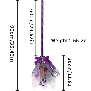 Detail of Halloween witch broom with purple ribbon bow and gold foil mesh bristles