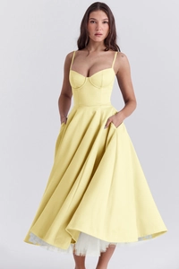 Detail of lemon yellow princess gown with corset bodice and white tulle lining
