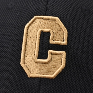 Detail of 3D embroidered gold letter C on black honeycomb mesh baseball cap fabric