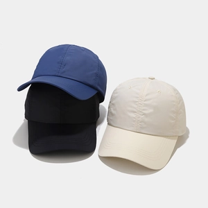 Close-up of quick-dry nylon sun hats in blue, black, and beige with breathable texture