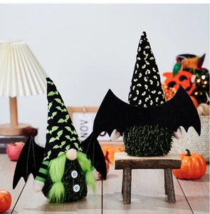 Detailed view of Halloween gnomes featuring green tinsel beards and black bat wings