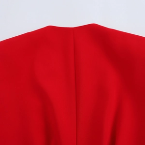 Close-up of the high-quality stitching on the back neckline of this red woven suit vest