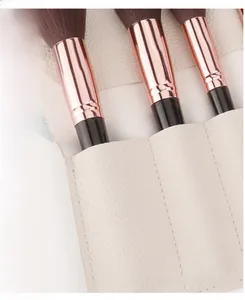 Detail of beige lychee grain PU makeup brush roll with internal dividers and compartments