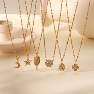 Detailed set of six 18K gold plated stainless steel necklaces with sparkling crystal charms