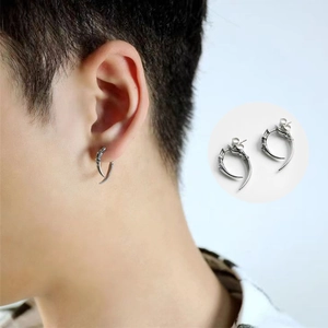 Macro view of silver punk claw earrings with professional on-ear model showcase