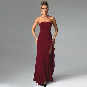 Detail view of burgundy strapless gown featuring elegant side slit and ruffle trim
