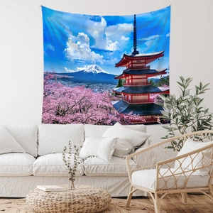 Detail of Mount Fuji tapestry with cherry blossoms hanging over a modern sofa