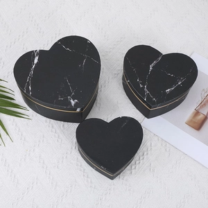 Three-piece heart-shaped gift box set with black marble pattern and golden trim details
