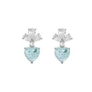 Macro shot of silver stud earrings with heart-shaped blue stones and pear-cut zirconias