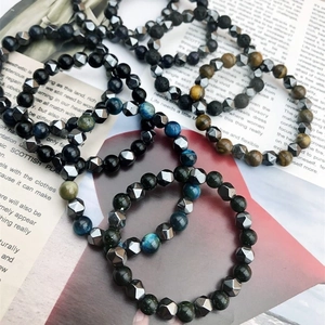 Stacked natural tiger eye and hematite beaded bracelets with geometric metal accents