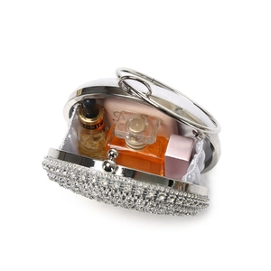 Luxury evening bag with white rhinestones and metal handle showing interior capacity