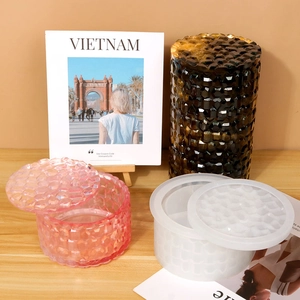 Macro detail of cylindrical silicone resin molds and finished faceted jewelry storage jars