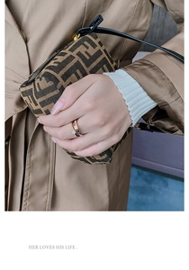 Detail of rose gold double-layered ring with a large zircon and pavé accents on finger