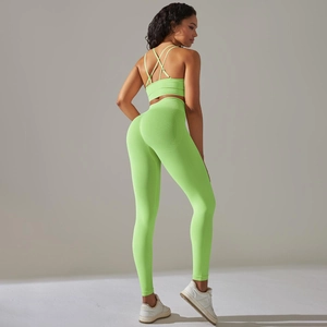 Detail of cross-strap back design and seamless ribbed texture on neon green yoga set