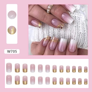 Pink gradient press-on nails with luxury gold foil flakes in medium square-oval shape
