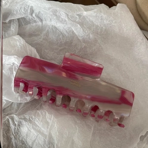 Detail showing the pink marble acetate hair claw with France Handmade gold lettering