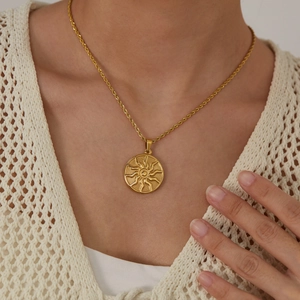 Vintage gold sun pendant necklace for women with elegant twisted chain on model