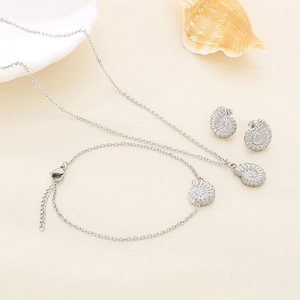 Detailed set of silver conch shell jewelry including necklace, bracelet and stud earrings
