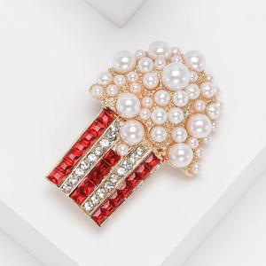 Creative popcorn brooch with white pearls and red crystal stripes on gold base