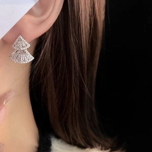 Close-up of elegant double-layered fan earrings with sparkling zircon on a model