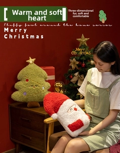 Close-up of soft plush Santa Claus and Christmas tree cushions with star details