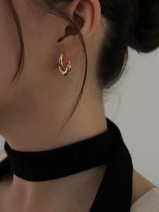 Minimalist 925 sterling silver heart hoop earrings in gold finish worn by model