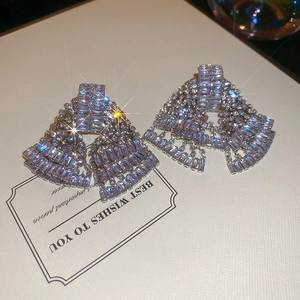 Macro shot of silver tassel earrings with glittering diamonds in a trapezoid shape