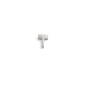Macro shot of a polished 3D stainless steel letter T charm for DIY jewelry making