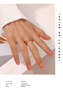 Close-up of a stylish gold Cuban link chain ring worn on a woman's finger