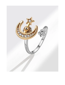 Detailed macro of a rotating star and moon ring with sparkling zircon inlays