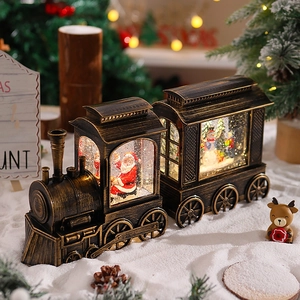 Detail of vintage bronze Christmas train snow globe featuring Santa and a snowman scene