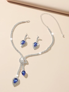 Detailed view of silver bridal jewelry set with blue teardrop stones and tassels