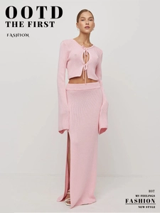 Detail of pink knitted long sleeve tie-up crop top and side slit high waist maxi skirt